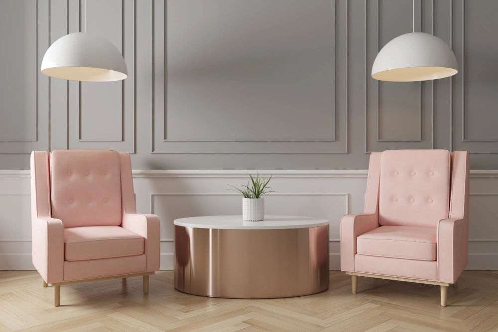 Two pink chairs positioned around a white table in a bright, inviting room.