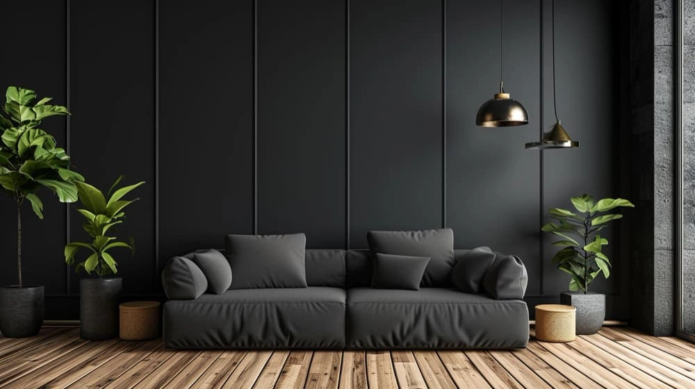 A sleek black sofa in a contemporary living room featuring a wooden floor and decorative plants.