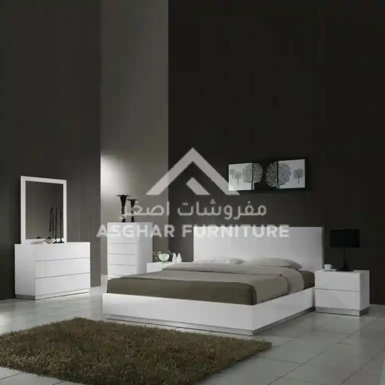 Modern bedroom featuring a white bed and dresser, showcasing sleek design and contemporary style.