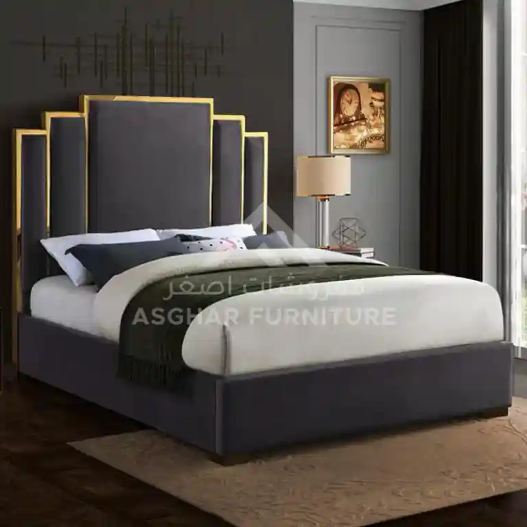 A sleek modern bed featuring a black headboard and elegant gold accents, showcasing contemporary design elements.