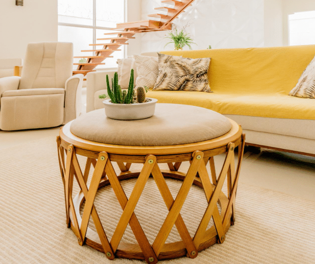 A cozy living room featuring a bright yellow couch and a matching yellow chair, creating a cheerful atmosphere.