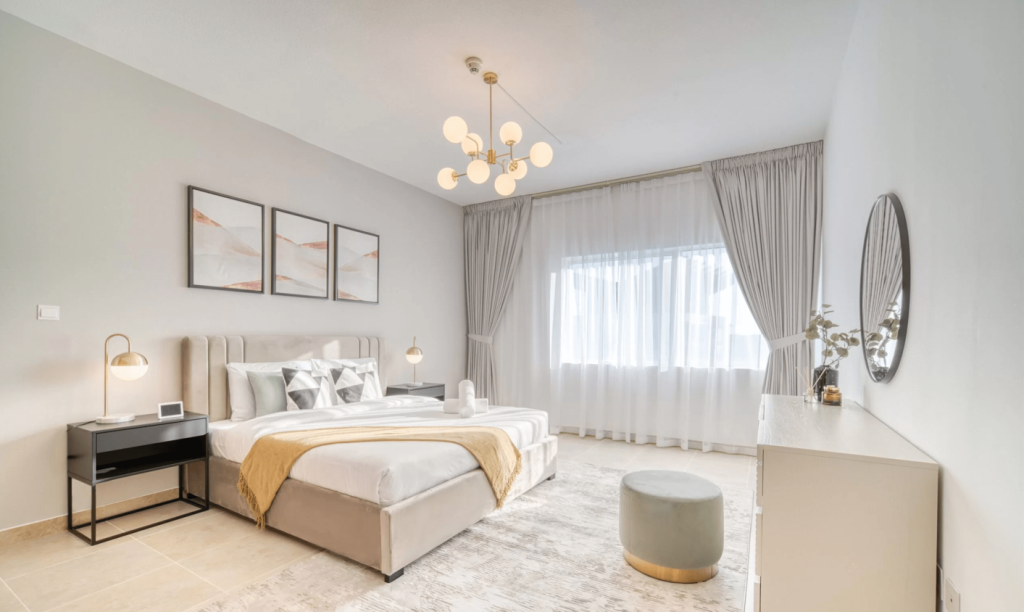 A cozy bedroom featuring a neatly made bed, a comfortable chair, and a stylish lamp illuminating the space.